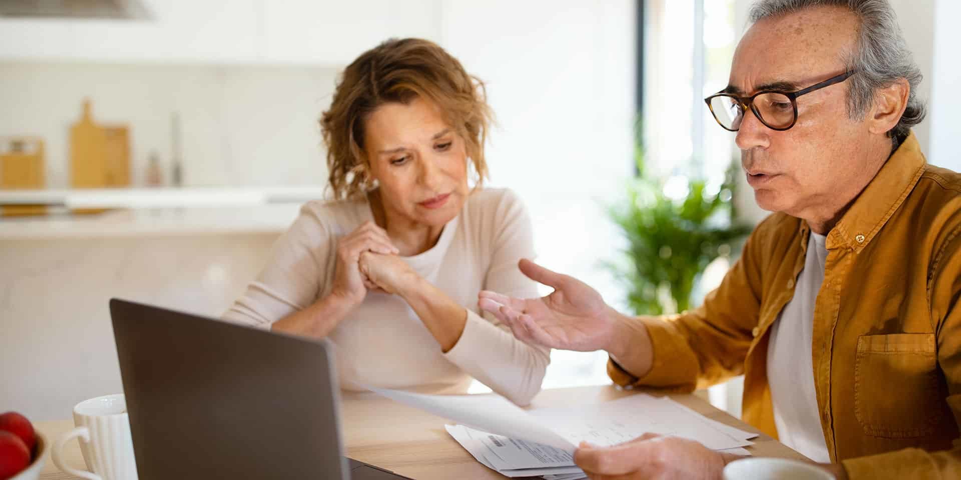 Couple examinant une facture, s’interrogeant sur sa valeur comme preuve de paiement Couple examinant une facture, s’interrogeant sur sa valeur comme preuve de paiement